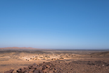 Panoramic view of the ancient seabed of the black desert of Morocco with close to the old abandoned...