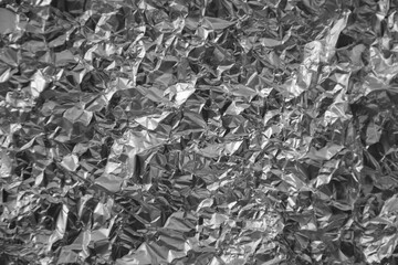 Processed collage of shiny metal silver gray foil crumpled packaging material texture