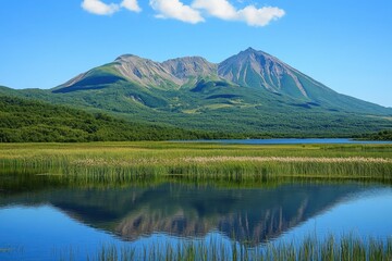 Scenic view of mountains reflecting in tranquil lake under clear blue sky