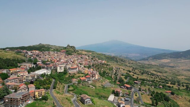 View of the city of Cesaro with Mount Etna in the background