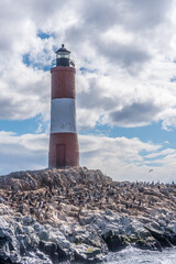 Les Eclaireurs lighthouse with cormorants on rocky island in Beagle Channel