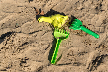Colorful children's toys in a sandbox