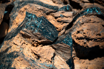 Lava formations, stones, black basalt in the rocks closeup on a volcano terrain.