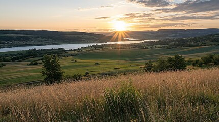 Obraz premium Sunset over lake and fields.
