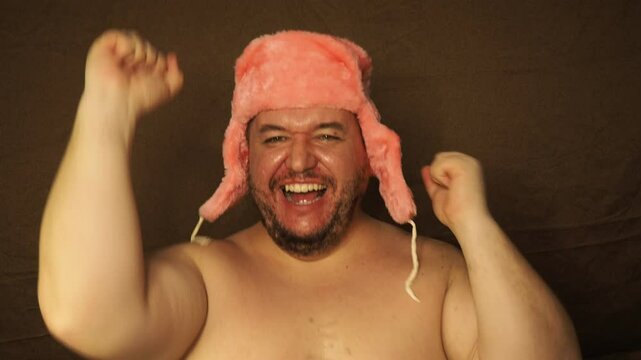 Funny fat man dancing at home.