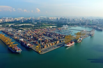 Naklejka premium Aerial View of a Busy Shipping Port in Mid Afternoon Light Showcasing Rows of Colorful Containers and Docked Ships with City Skyline in the Background