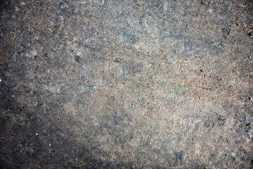 Concrete surface with crack texture and pebbles. Gray bluish concepts and vintage background that can be used for design, banners or texturing.