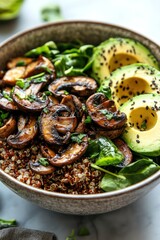 Fototapeta premium A nutritious bowl featuring quinoa, saut?ed mushrooms, spinach, and avocado slices.