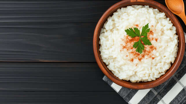 Creamy arroz doce is served in a rustic bowl, garnished with fresh herbs and spices