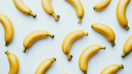 Ripe bananas arranged creatively on a bright white background showcasing vibrant colors and natural textures for food photography.