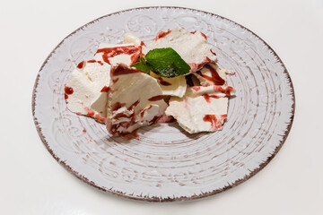 Meringue and mascarpone dessert on dish on white table
