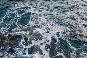 Fragment of sea surface with water roughness and sea ​​foam