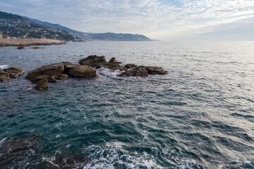 Stone shore of sea against the sky in overcast morning