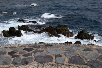 Deserted Stone Promenade and Rocks with Breaking Sea Waves 