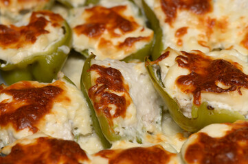 Creamy stuffed peppers bake to golden perfection in a cozy kitchen filled with savory aromas