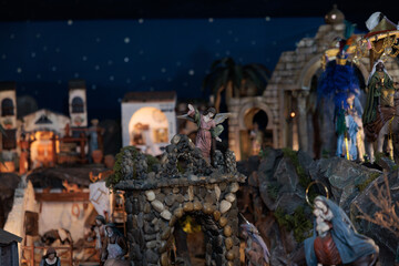 Fototapeta premium Angel figurine standing on stone arch in christmas nativity scene