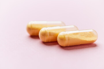 Coenzyme Q10 capsules. Antioxidants. Concept for a healthy dietary supplementation. Bright paper background. Soft focus. Close up. Copy space.