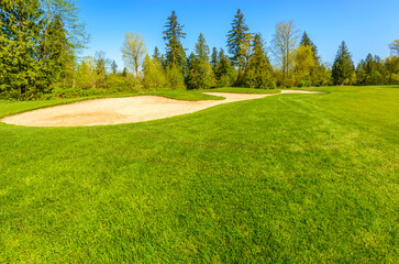 Golf course with gorgeous green and sand bunker