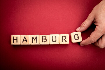 Hamburg. Word from wooden alphabet blocks on a red background