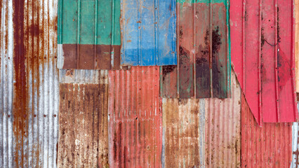 multi-colored roof covered with different old rusty materials of various colors