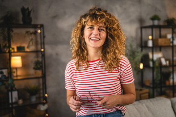 portrait of beautiful woman with curly hair smile at home
