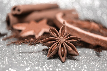 Demonstrating color of the year 2025. Mocha mousse color swatch. Christmas spices, pine and spruce branch on defocused white bokeh background. Winter holiday