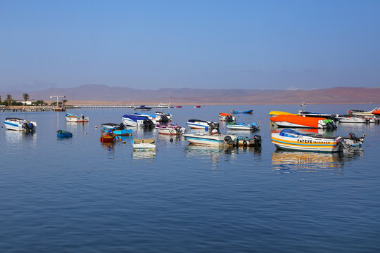 PARACAS, PERU-JANUARY 26: Colorful fishing boats anchored in Paracas Bay on January 26, 2015  in Paracas, Peru. Paracas is a small port town catering to tourists visiting Paracas Reserve