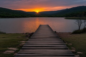 Naklejka premium Stunning sunset viewed from a wooden dock by the lake