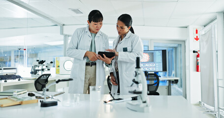 Scientist, women and collaboration for research, notes and experiment results or medical information. Tablet, update and laboratory technician with documents for virus development or pathology test