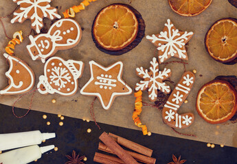 christmas baked gingerbread snowflakes cookies with evergreen twigs on wood, color of the year 2025 mocha mousse