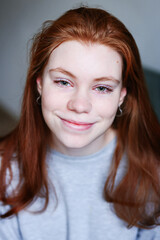 Close up portrait of young red hair girl at the isolated white background with copy space