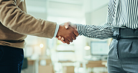 Business people, handshake and meeting with teamwork for agreement, deal or partnership at office. Closeup, employees or colleagues shaking hands for negotiation, hiring or recruiting at workplace