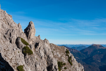 Panoramic view from top of mountain peak Piper in Julian Alps, Friuli Venezia Giulia, Italy. Vista on unique massive rock formation overlooking distant mountain ranges High Tauern in Austrian Alps