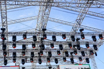 Fragment of metal trusses and lighting elements of a large outdoor concert stage