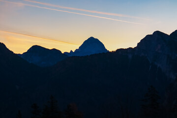 Dramatic silhouette of mountain peak Mangart at twilight in Julian Alps, Friuli Venezia Giulia,...