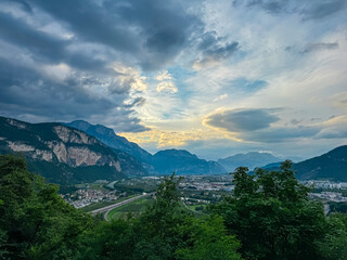 Breathtaking aerial view of city of Trento nestled amidst cloud covered mountainous landscape in Trentino Alto Adige, Italy. Vantage point from Terrazza Panoramica Busa Degli Orsi. Tourist destination