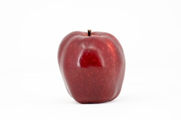 A bright red apple with a glossy, shiny peel, beautifully displayed against a clean white background