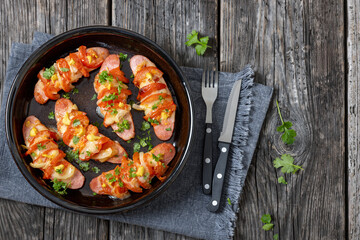 hot sausages baked with cheese, tomato, mustard