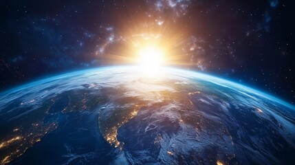 Earth at dawn with the sun rising over the horizon illuminating the atmosphere in vibrant colors