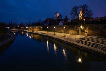 alone the river in Györ, Hungary, at the blue hour at night