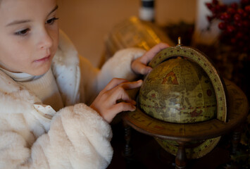 6 year old girl long blonde hair playing with a world map