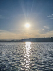 Sunlight Reflection on Calm Lake Surface at Dusk