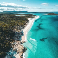 Fototapeta premium An aerial view of a tropical coastline featuring turquoise water, white sand beaches, and gentle waves, captured in high detail, evoking serene and vibrant vacation vibes