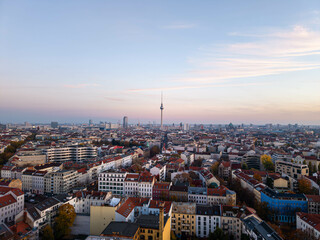 Golden hour sunset over Berlin cityscape with iconic landmarks and residential buildings, creating a stunning urban landscape in Germany Capital
