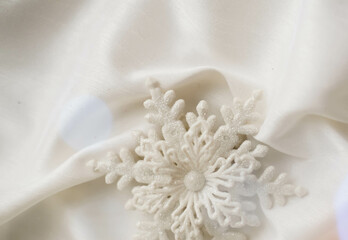 Minimalist Winter Decor: Snowflake on Draped Fabric