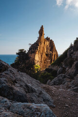 a landscape of a stone cliff in the warm sunset