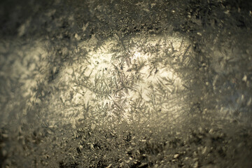 Frozen glass. Snowflakes on the window. Frosty snowflakes on glass.