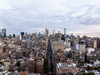 Breathtaking aerial view of Midtown Manhattan, featuring iconic skyscrapers like the Empire State Building and Chrysler Building amidst a vibrant urban sprawl