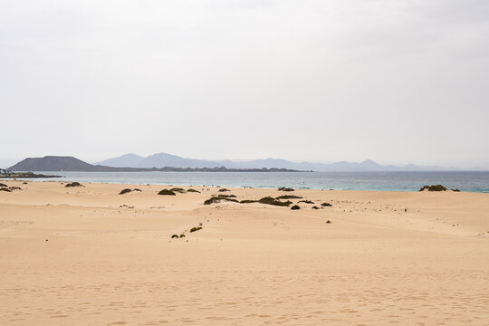 Sandy beach and distant mountains on Lobos Island scenery