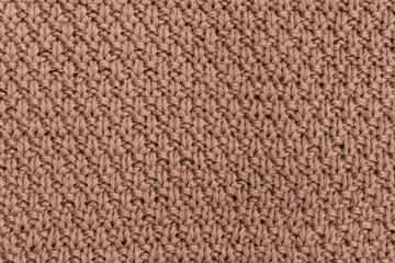 Fototapeta premium Knitted pearl wool background. Demonstrating color of 2025 year mocha mousse
